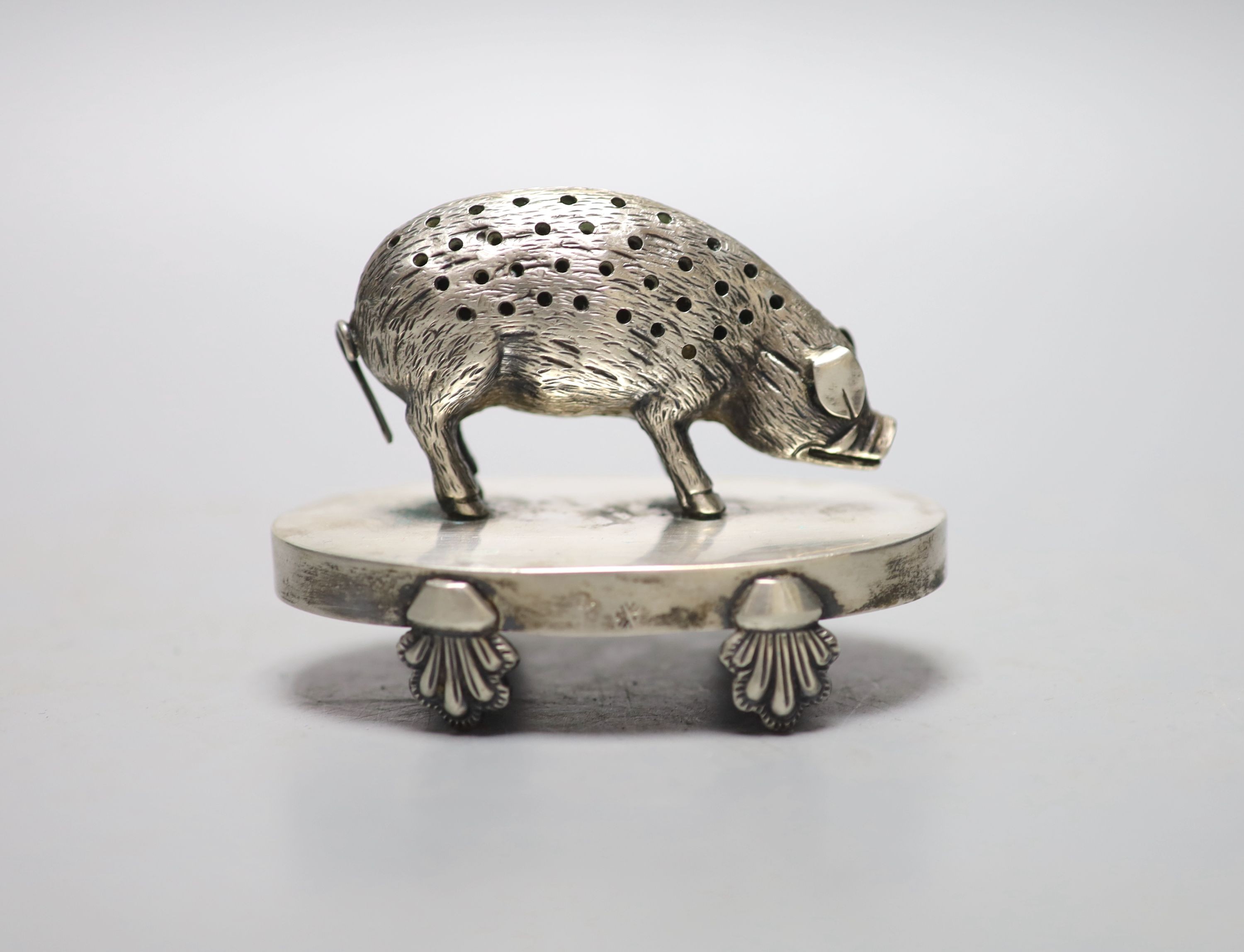 A continental white metal novelty oval toothpick holder, modelled as a pig on an oval base, 91mm, indistinct marks.